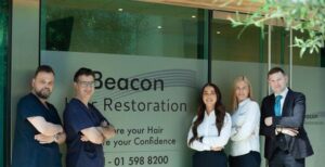 Beacon Hair Restoration team outside the branded clinic entrance